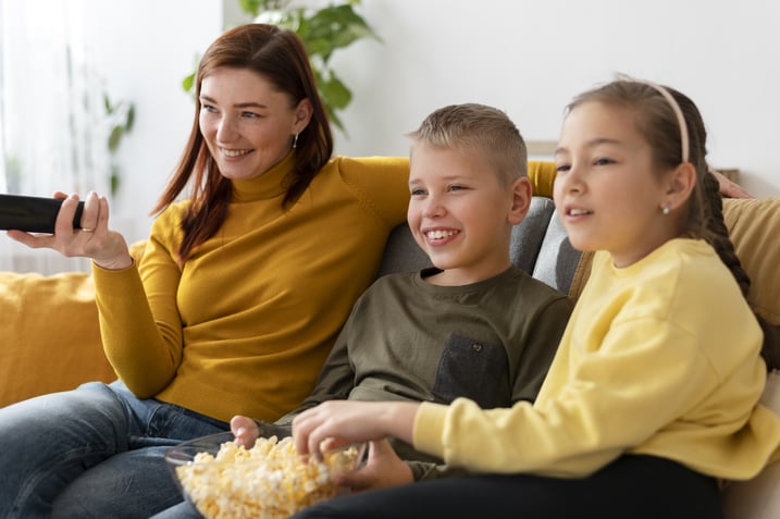 mom-watching-television-with-her-children